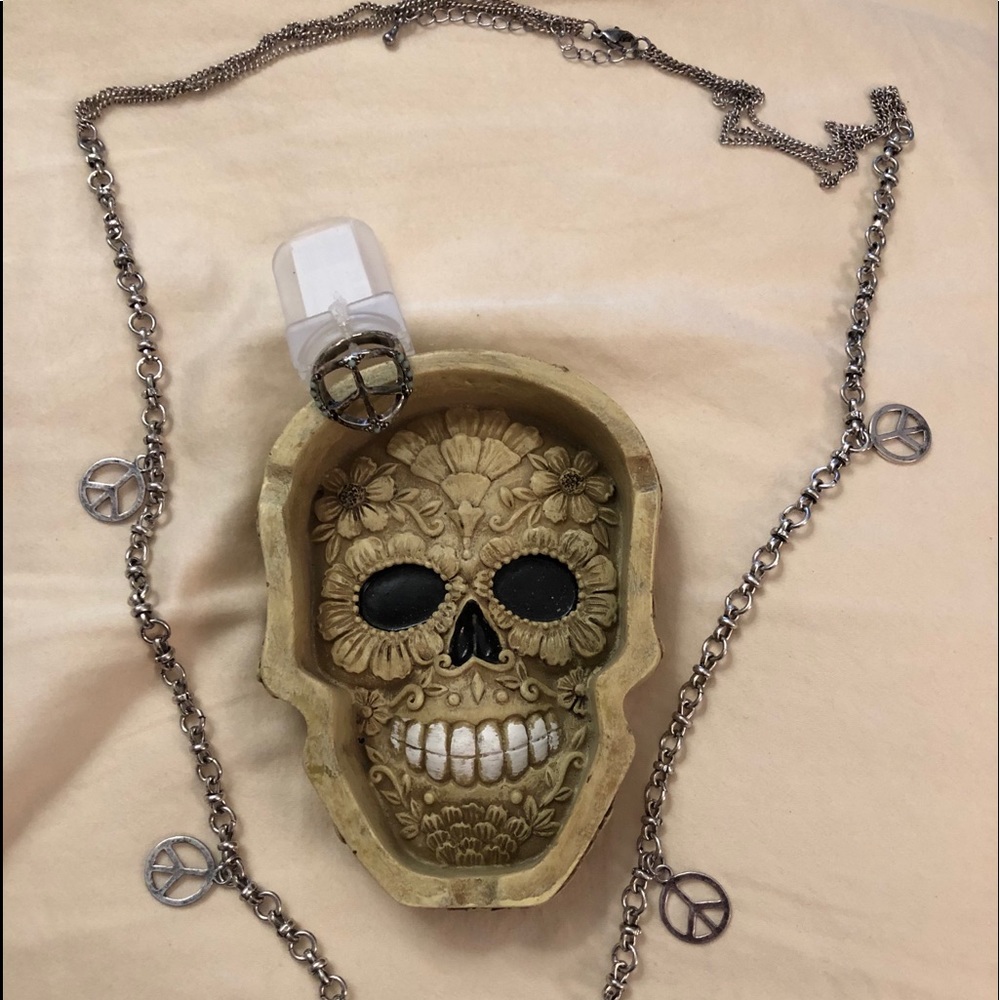 Jewelry holder with peace necklace and ring